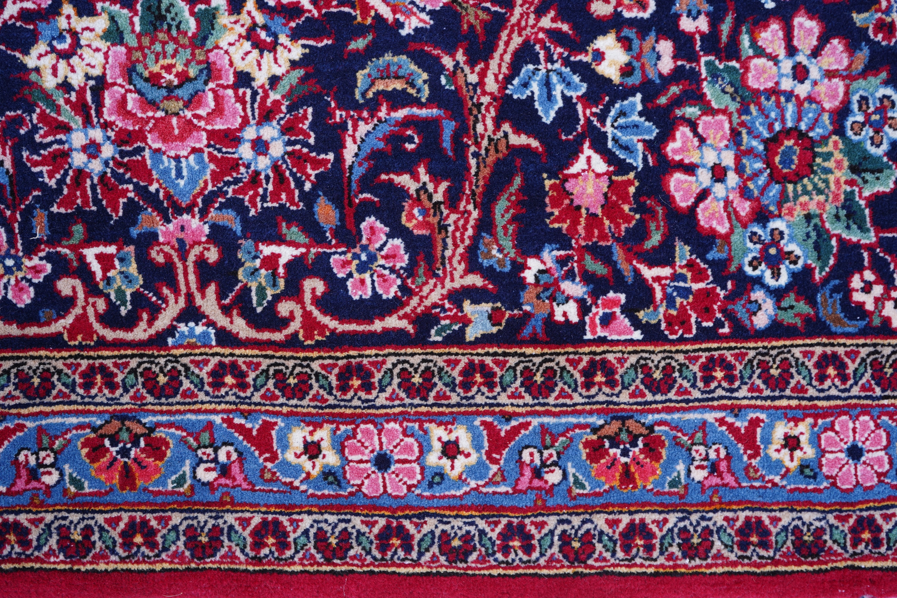 A Kashan burgundy ground carpet
